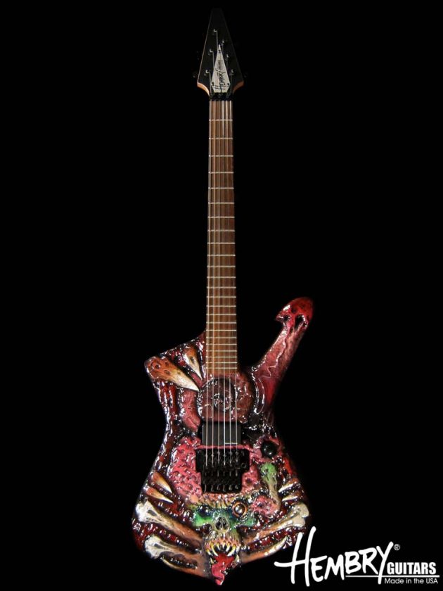 love this guitar. From the wild carving and paint to the inlayed 