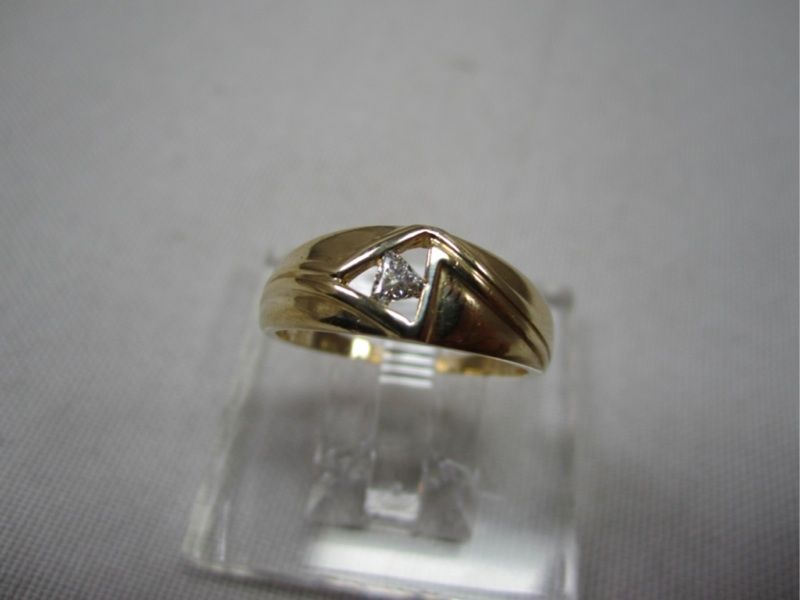 One 14k yellow gold ring with trilliant cut Diamond. Diamond is 